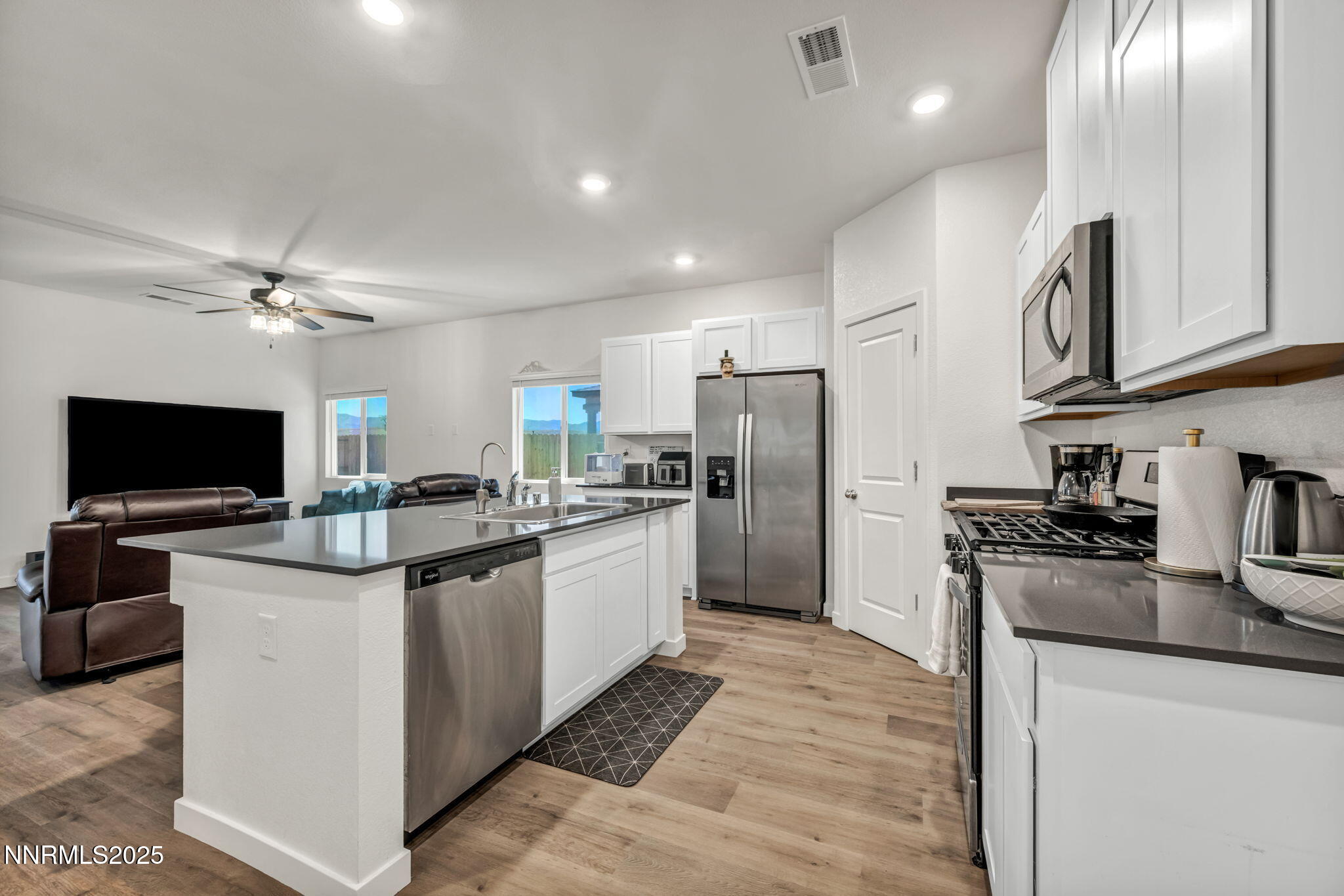 1019 Anthony Court Fernley, NV 89408 - Photo 5 of 55 a kitchen with stainless steel appliances kitchen island granite countertop a refrigerator and a stove top oven