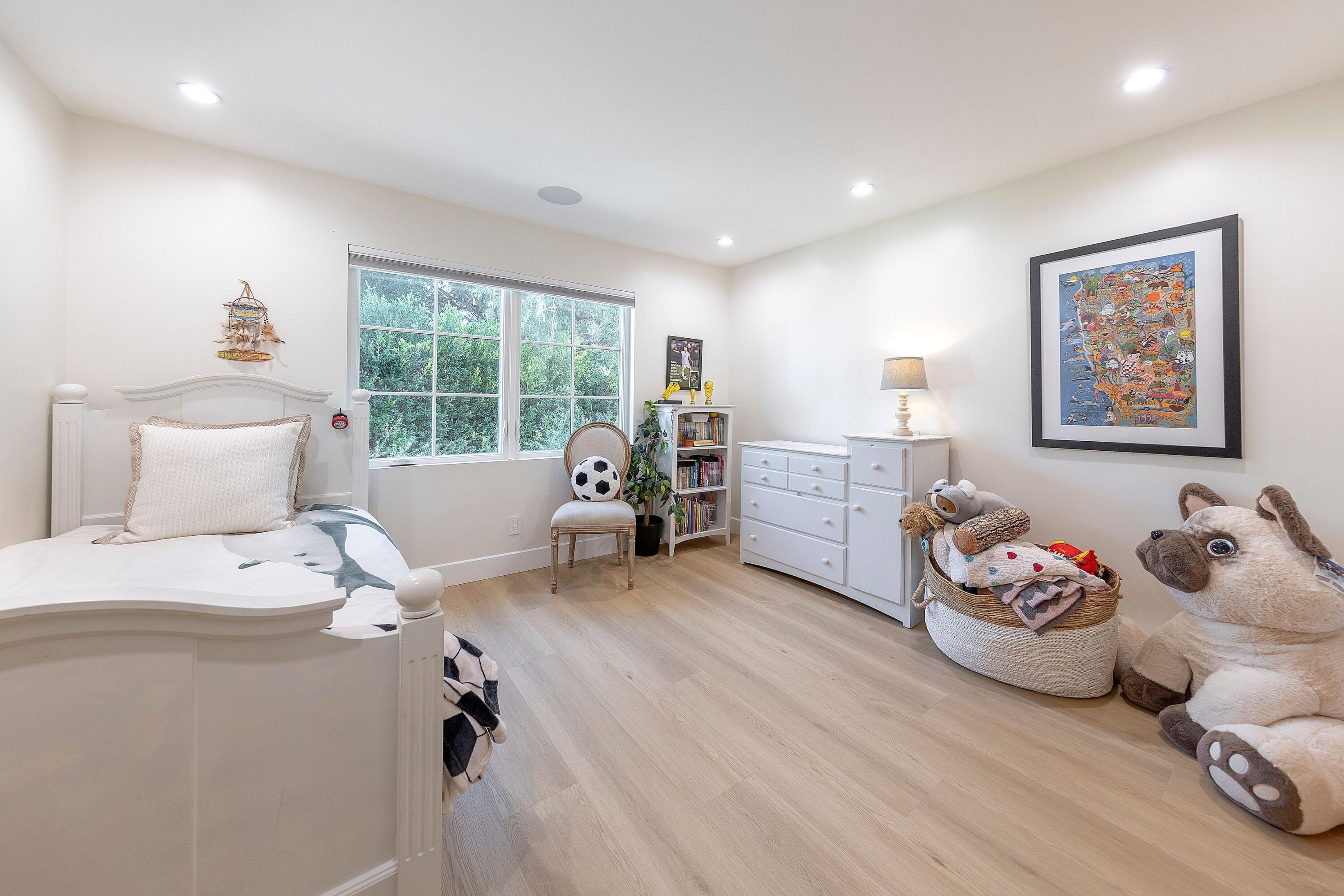 487 Hot Springs Road Santa Barbara, CA 93108 - Photo 13 of 47 a bedroom with furniture and a wooden floor