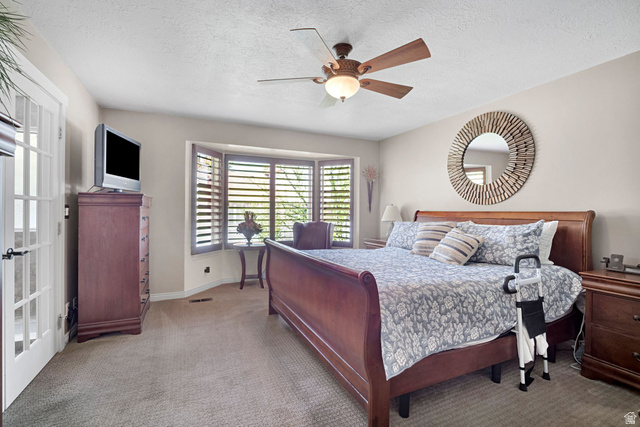2139 Village Point Way Sandy, UT 84093 - Photo 12 of 35 Primary bedroom with bay window and wood plantation shutters. French doors to primary bathroom.