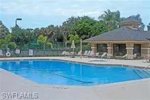 a outdoor view of house with swimming pool and furniture