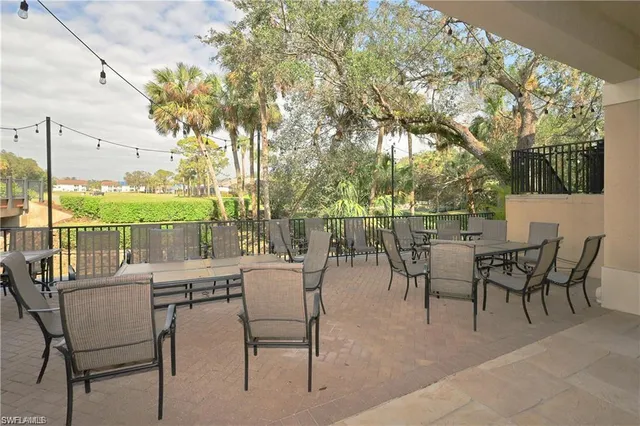 a view of a patio with a table and chairs