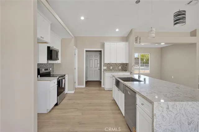 an empty room with windows and fireplace