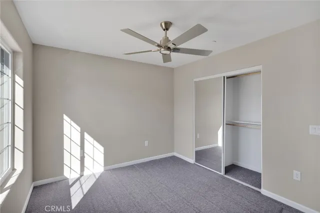 a bathroom with a granite countertop toilet sink and mirror