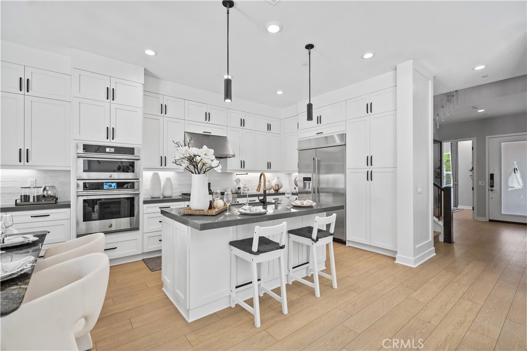 598 Alder Way Montebello, CA 90640 - Photo 13 of 56 a kitchen with stainless steel appliances kitchen island granite countertop a stove and a refrigerator