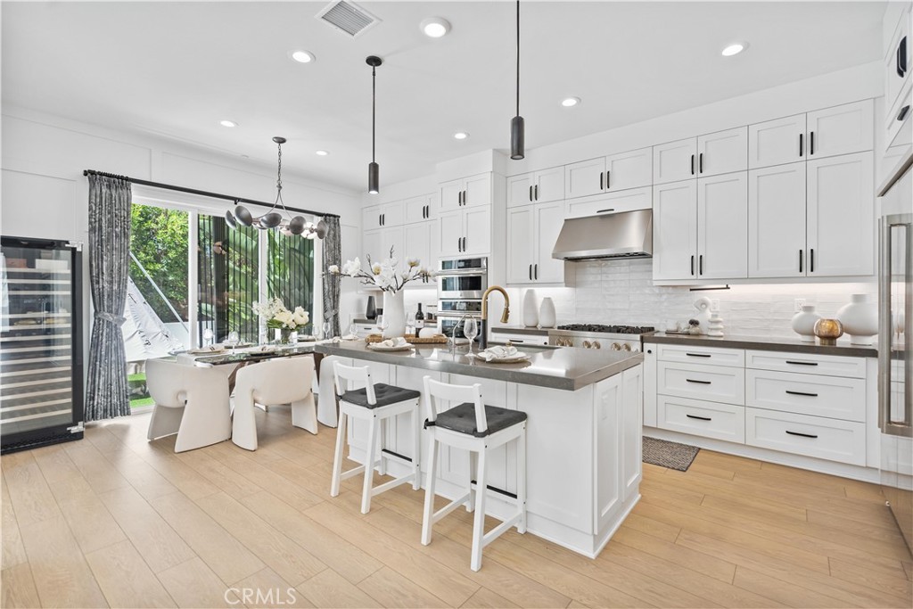 598 Alder Way Montebello, CA 90640 - Photo 14 of 56 a kitchen with white cabinets stove and white appliances
