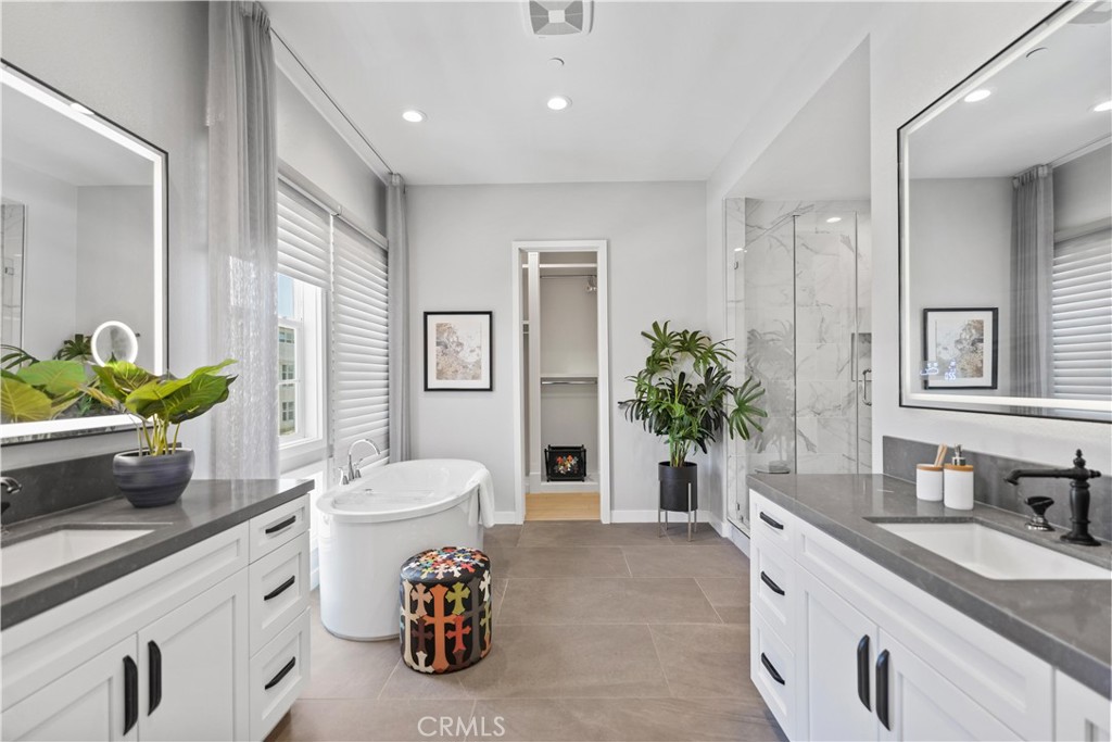 598 Alder Way Montebello, CA 90640 - Photo 24 of 56 a bathroom with a granite countertop sink a large mirror and a shower