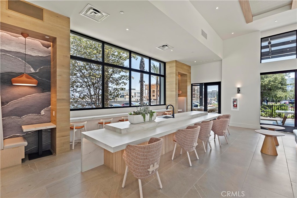 598 Alder Way Montebello, CA 90640 - Photo 49 of 56 a dining hall with stainless steel appliances a table and chairs with wooden floor