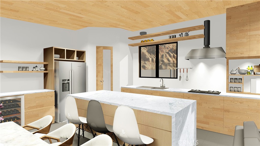 64845 Sun Oro Road Joshua Tree, CA 92252 - Photo 30 of 52 a kitchen with stainless steel appliances kitchen island granite countertop a table chairs in it and wooden floors