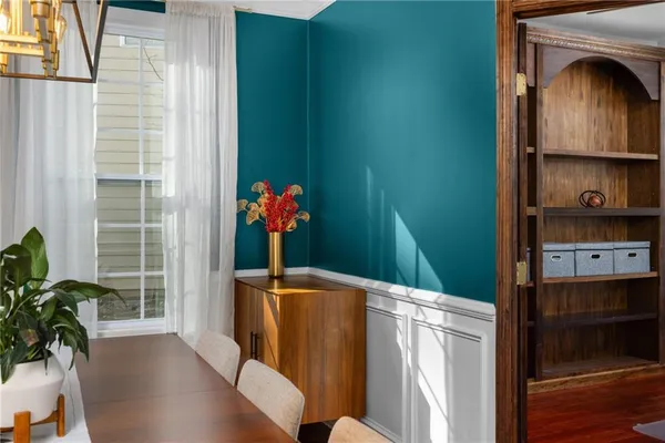 a dining room with furniture and wooden floor