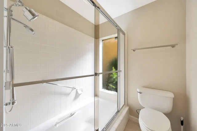 a bathroom with a toilet and a shower