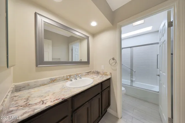 a bathroom with a sink a vanity and a mirror