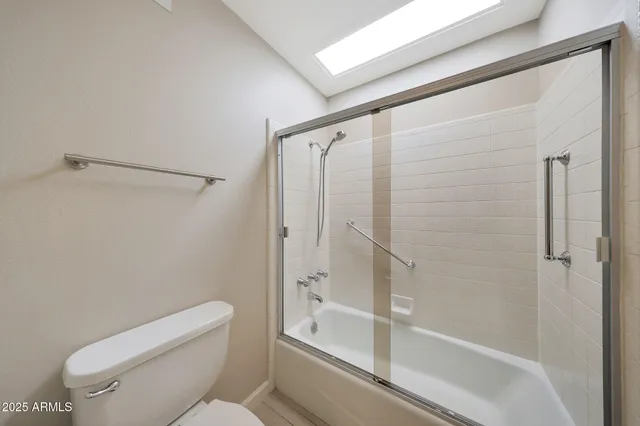 a bathroom with a shower a toilet and a shower