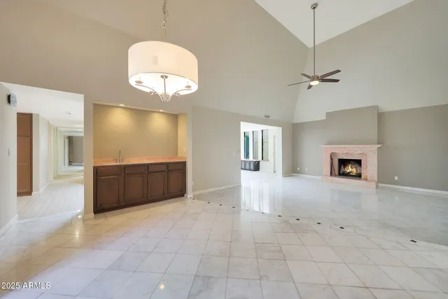 a view of an empty room with a fireplace and a window