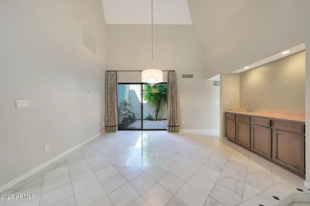 a view of a kitchen with furniture and chandelier