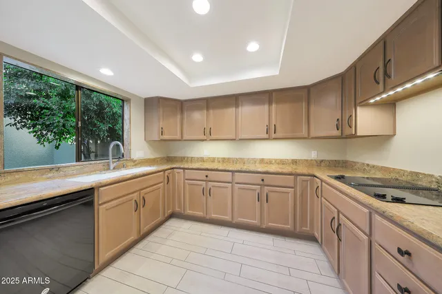 a kitchen with a sink stove and cabinets