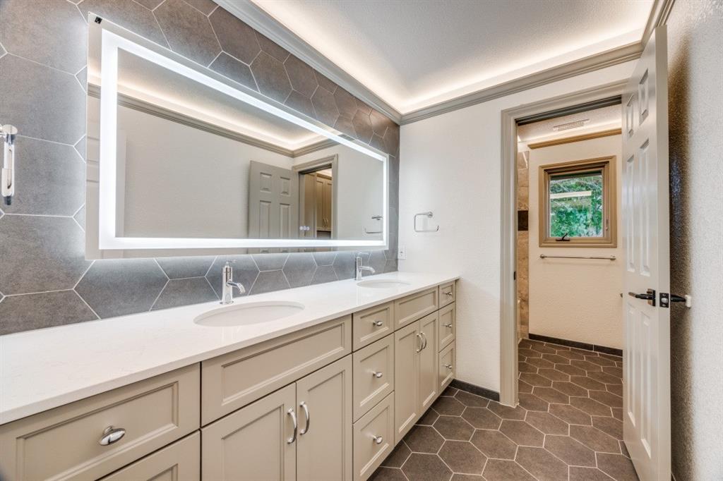 3244 Joe Davis Road Whitewright, TX 75491 - Photo 18 of 28 Bathroom with double vanity, tasteful backsplash, and tile patterned flooring
