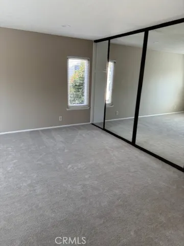 an empty room with windows and entrance