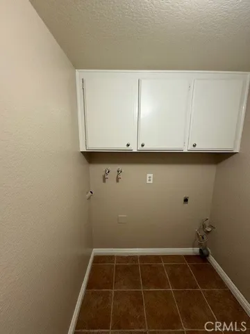a patio with a table and chairs and potted plants