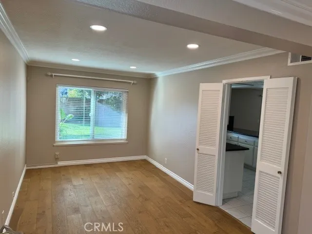 an empty room with a window and a hallway