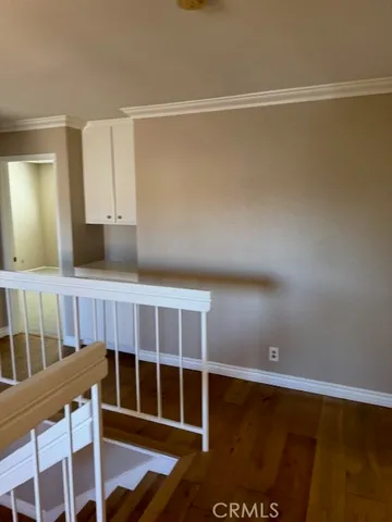 a view of a room with wooden floor and cabinet