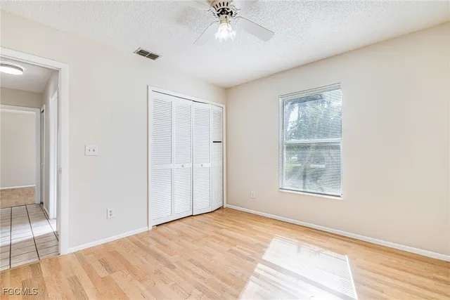 an empty room with windows and closet
