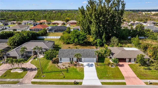 an aerial view of a house with swimming pool garden and patio