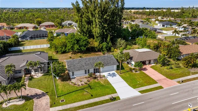 an aerial view of a house with garden space and street view