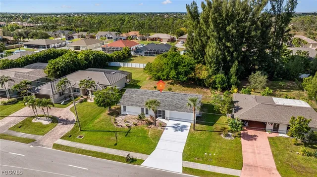 an aerial view of a house with garden space and street view