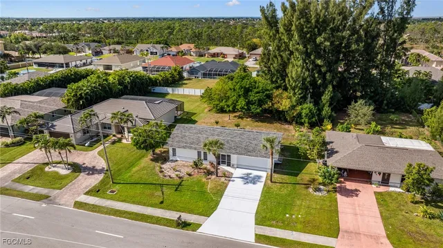 an aerial view of a house with garden space and street view