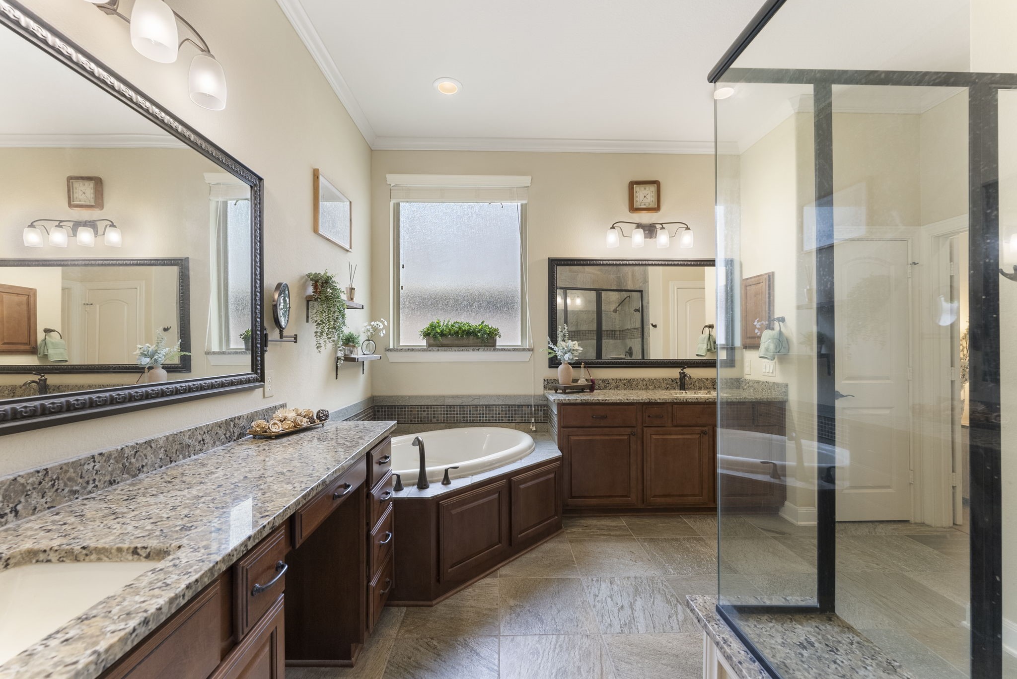 4787 Jackson Square Drive Conroe, TX 77304 - Photo 21 of 35 Step into your personal oasis—this en-suite primary bathroom is designed for pure indulgence. The oversized walk-in shower invites you to unwind under a cascade of water, while the luxurious soaking tub offers the perfect escape after a long day. Dual sinks and a spacious vanity provide ample room to get ready with ease, whether it’s for a busy morning or a relaxing evening. Every detail has been thoughtfully curated to elevate your daily routine into a spa-like experience.