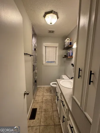 a bathroom with double vanity and a mirror