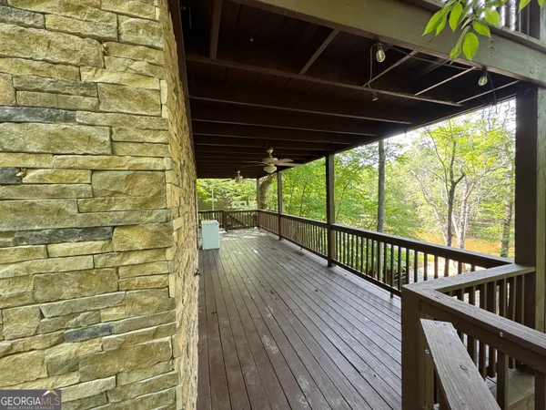 a view of a porch with wooden floor