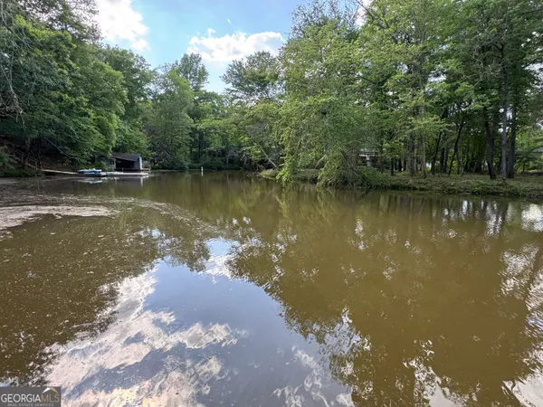 a view of a lake in between two trees