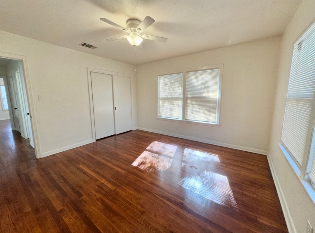 110 East 8th Street Elgin, TX 78621 - Photo 11 of 17 a view of empty room with wooden floor and fan