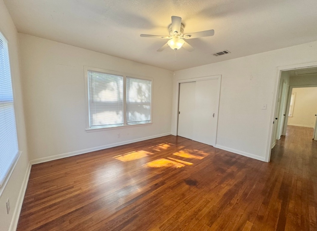 110 East 8th Street Elgin, TX 78621 - Photo 15 of 17 wooden floor in an empty room with a window