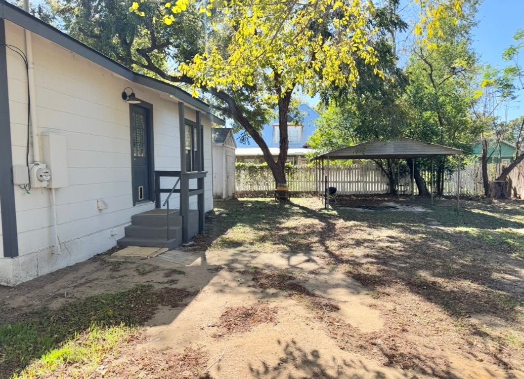 110 East 8th Street Elgin, TX 78621 - Photo 16 of 17 a backyard of a house with table and chairs
