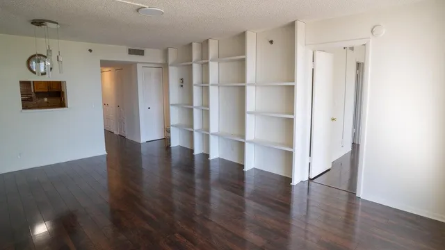 a view of walk in closet with wooden floor and window