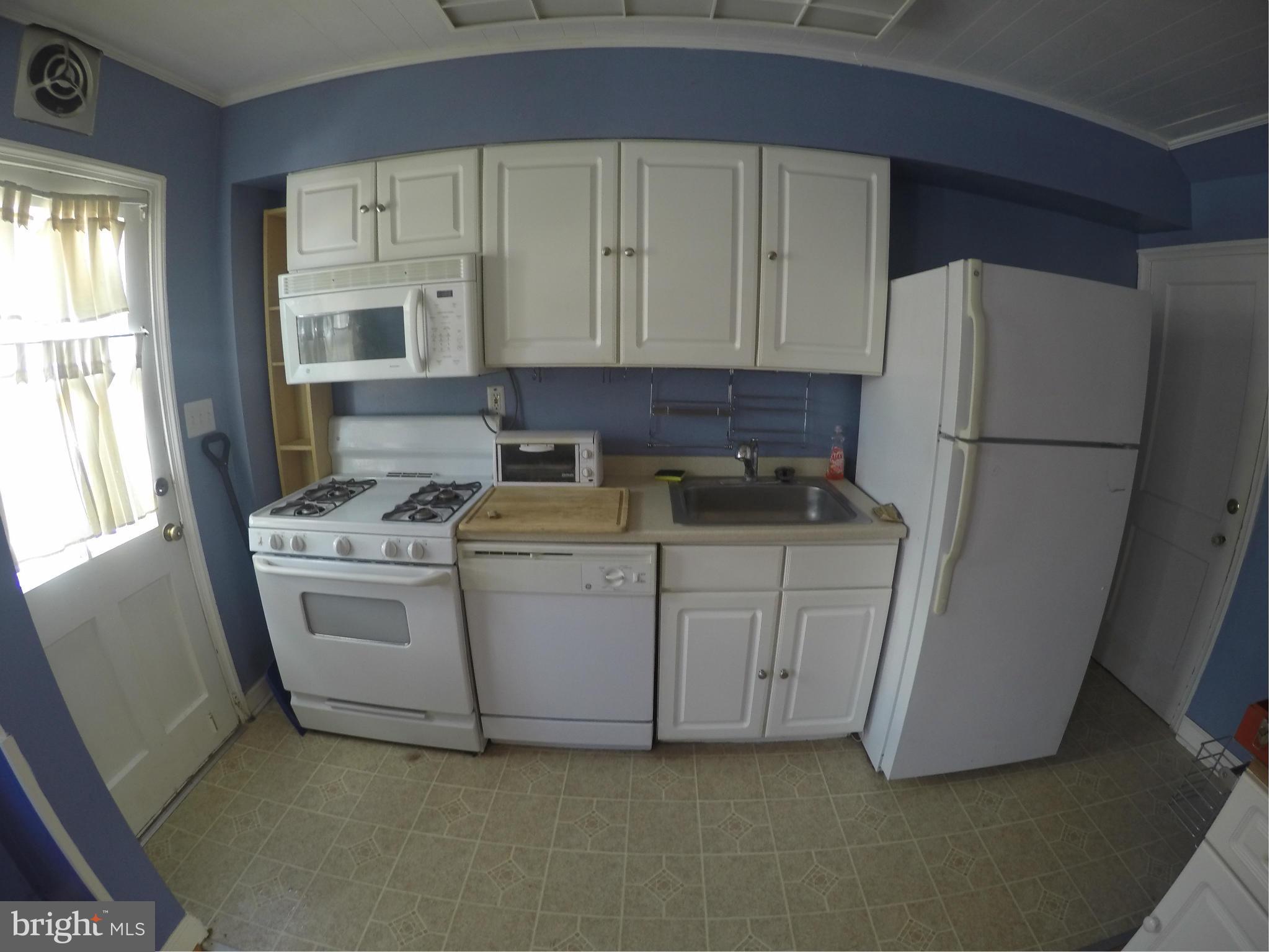 8326 Edgedale Road Baltimore, MD 21234 - Photo 4 of 9 a kitchen with cabinets appliances a sink and a window