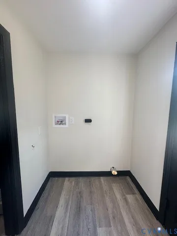 a view of a small space with wooden floor and a window