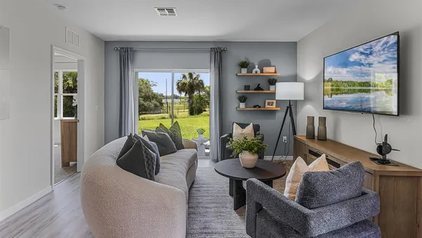 a living room with furniture and a flat screen tv