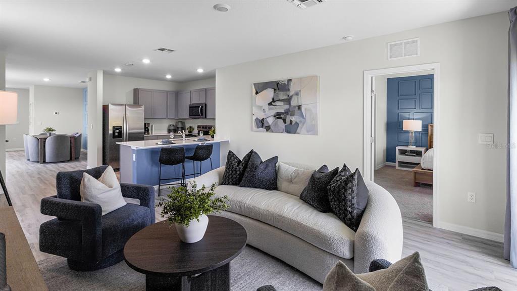3316 White Indigo Road Winter Haven, FL 33884 - Photo 15 of 27 a living room with furniture potted plant and kitchen view
