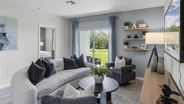 a living room with furniture and a potted plant
