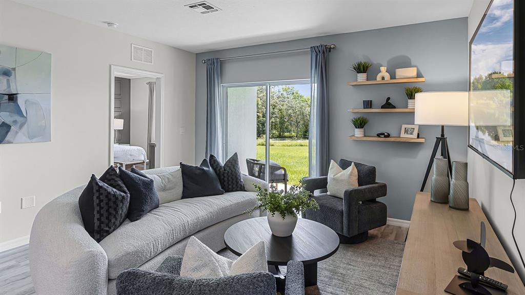 3316 White Indigo Road Winter Haven, FL 33884 - Photo 16 of 27 a living room with furniture and a potted plant