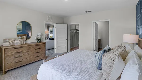 a bedroom with a bed and a dresser