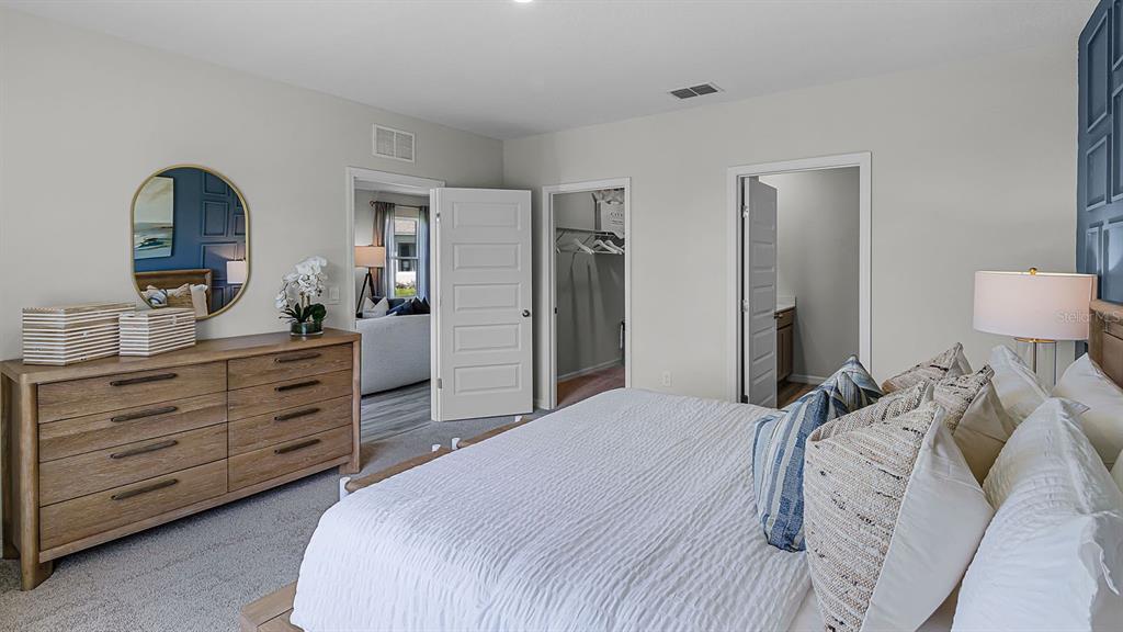 3316 White Indigo Road Winter Haven, FL 33884 - Photo 19 of 27 a bedroom with a bed and a dresser