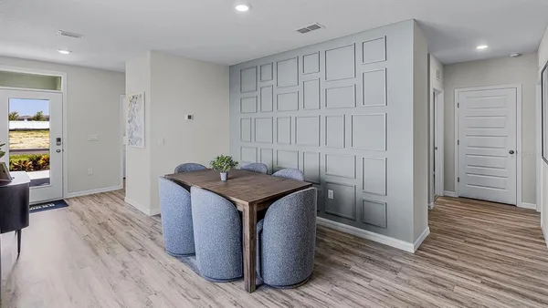 a kitchen with stainless steel appliances granite countertop a sink and a wooden floor