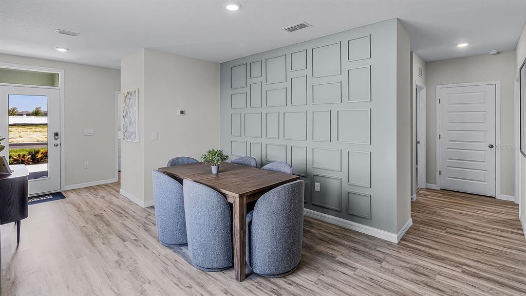 3316 White Indigo Road Winter Haven, FL 33884 - Photo 2 of 27 a kitchen with stainless steel appliances granite countertop a sink and a wooden floor