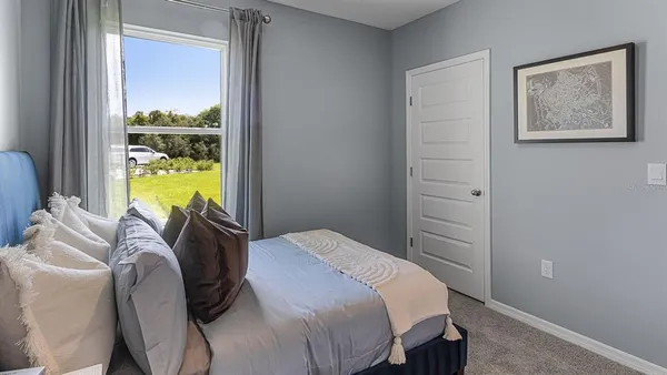 a bedroom with a bed and a window