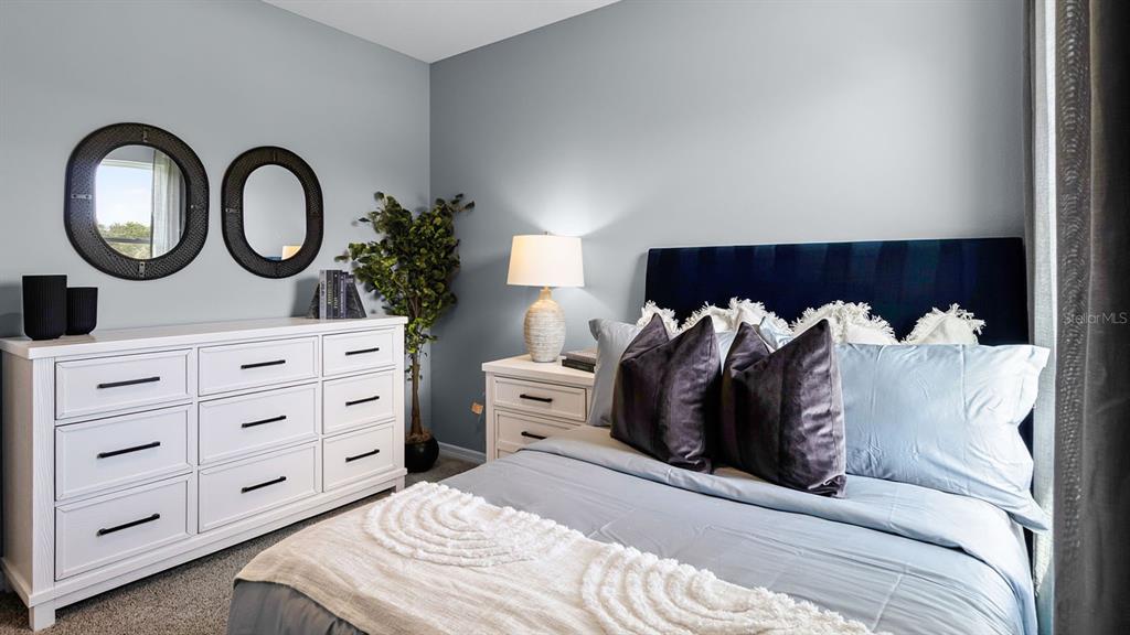 3316 White Indigo Road Winter Haven, FL 33884 - Photo 23 of 27 a bedroom with a bed and a large mirror on the dresser