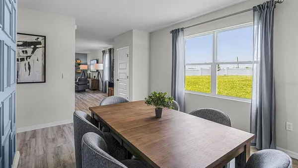 a view of a dining room with furniture and window